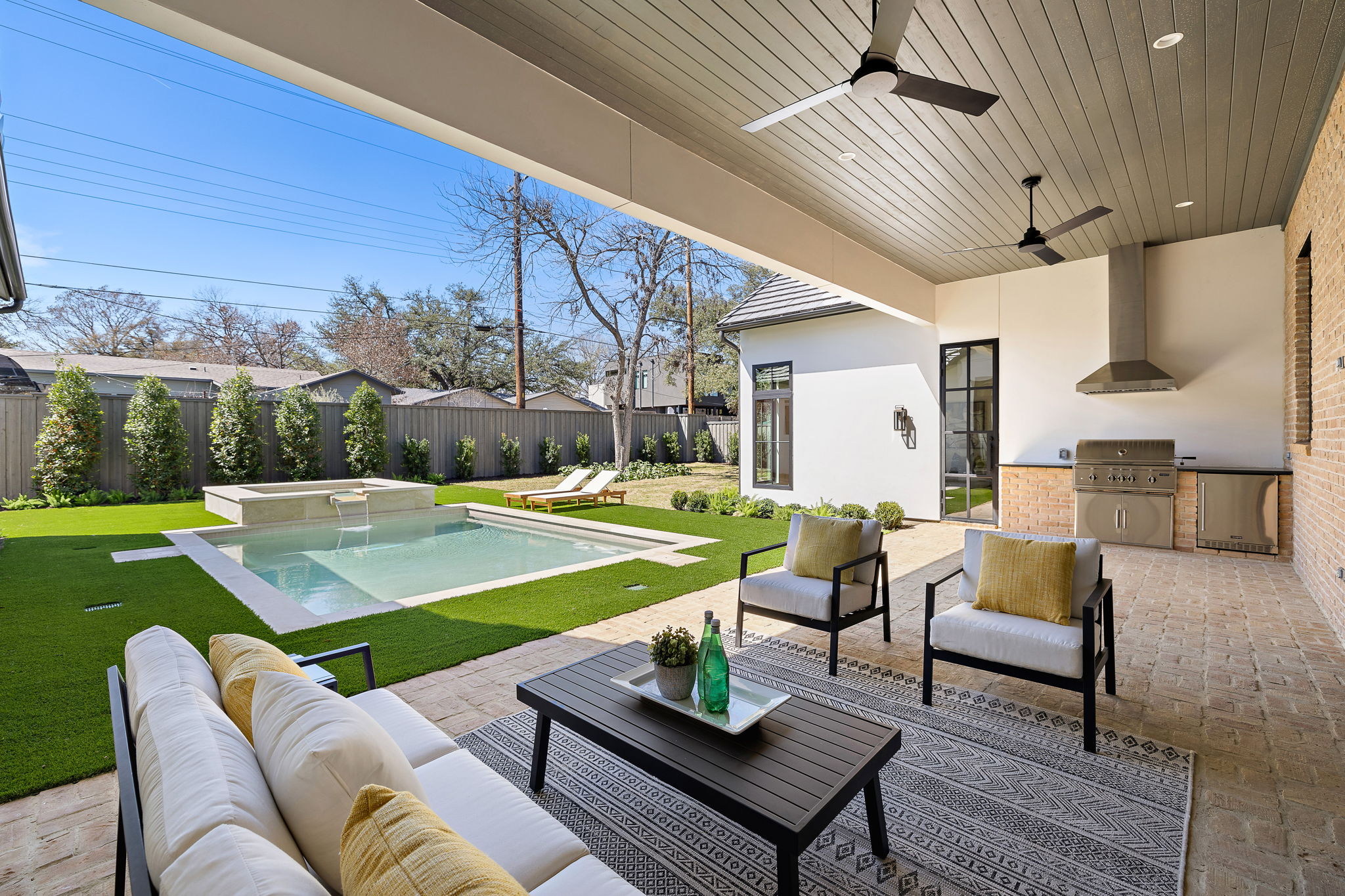 5906 Rickey Drive Austin, TX 78757 - Photo 35 of 38 a view of a patio with couches table and chairs with wooden floor and fence