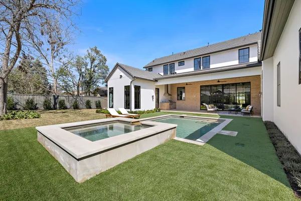 a view of a house with sitting area and swimming pool