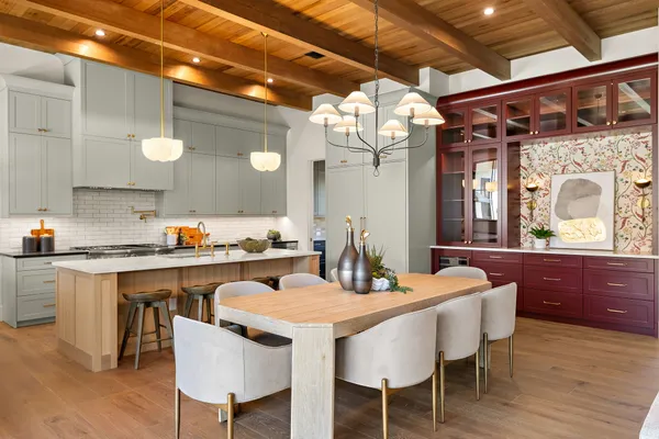 a kitchen with a dining table and chairs