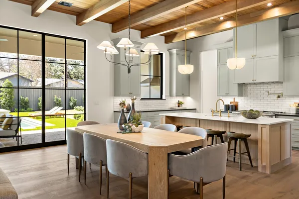 a large kitchen with a table and chairs