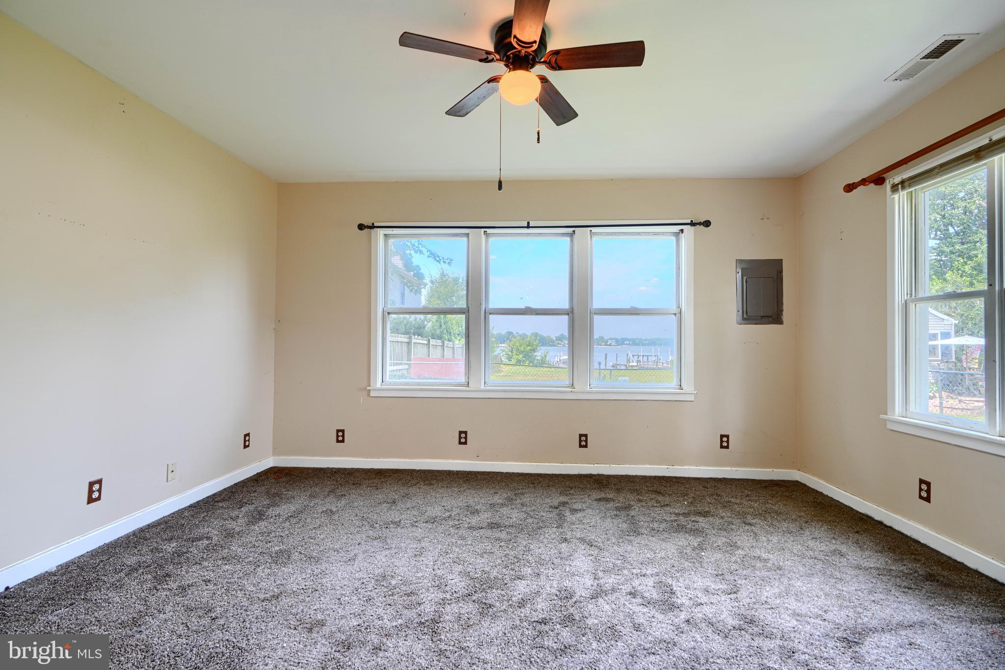 1702 Wilson Point Road Middle River, MD 21220 - Photo 11 of 32 an empty room with chandelier fan and windows