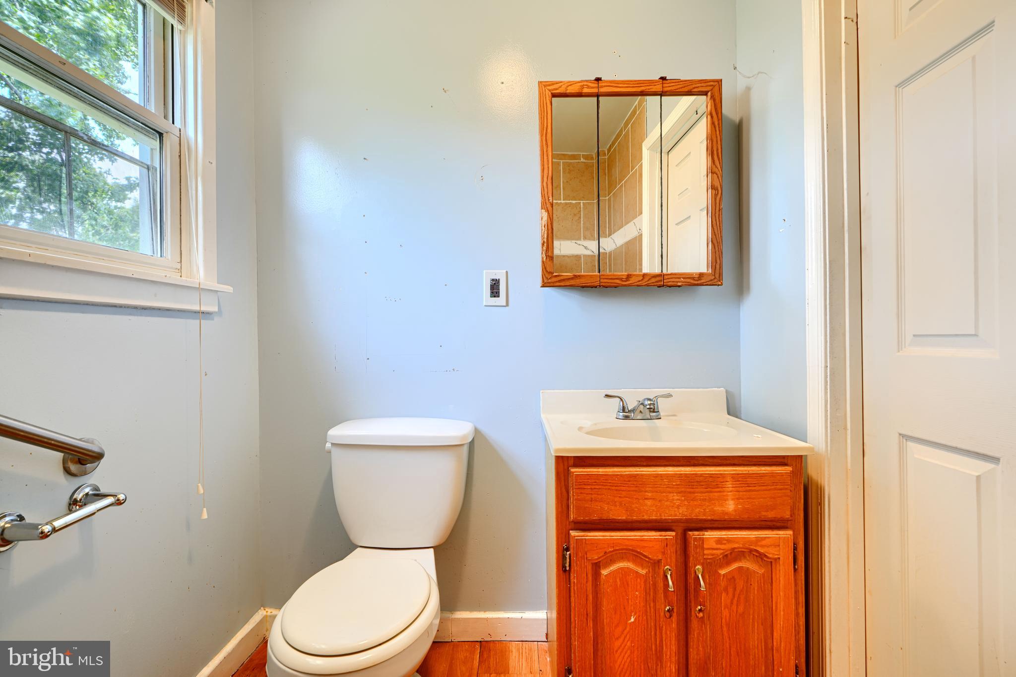 1702 Wilson Point Road Middle River, MD 21220 - Photo 16 of 32 a bathroom with a toilet sink and mirror