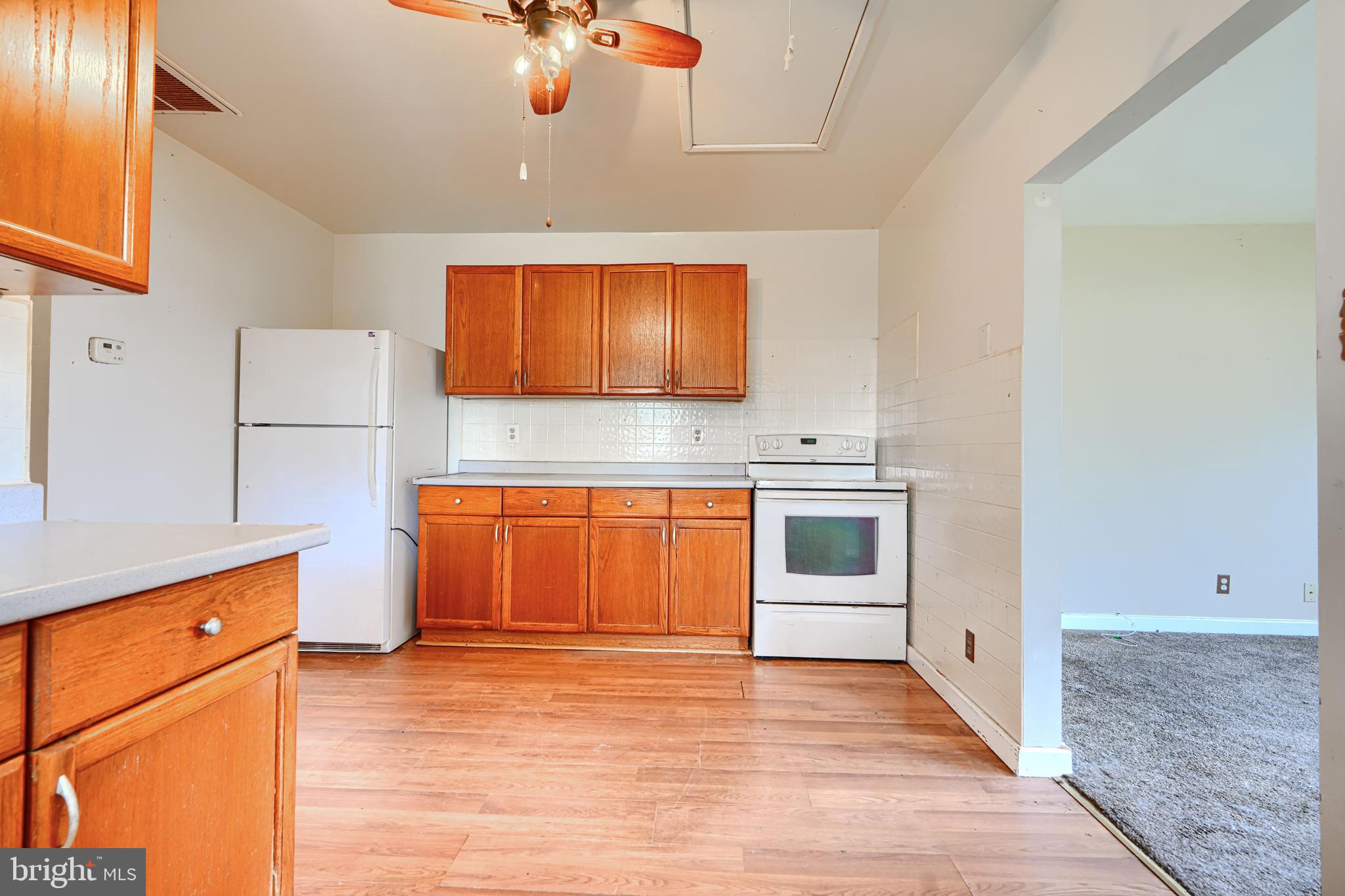 1702 Wilson Point Road Middle River, MD 21220 - Photo 6 of 32 a kitchen with stainless steel appliances granite countertop a stove a sink and a refrigerator