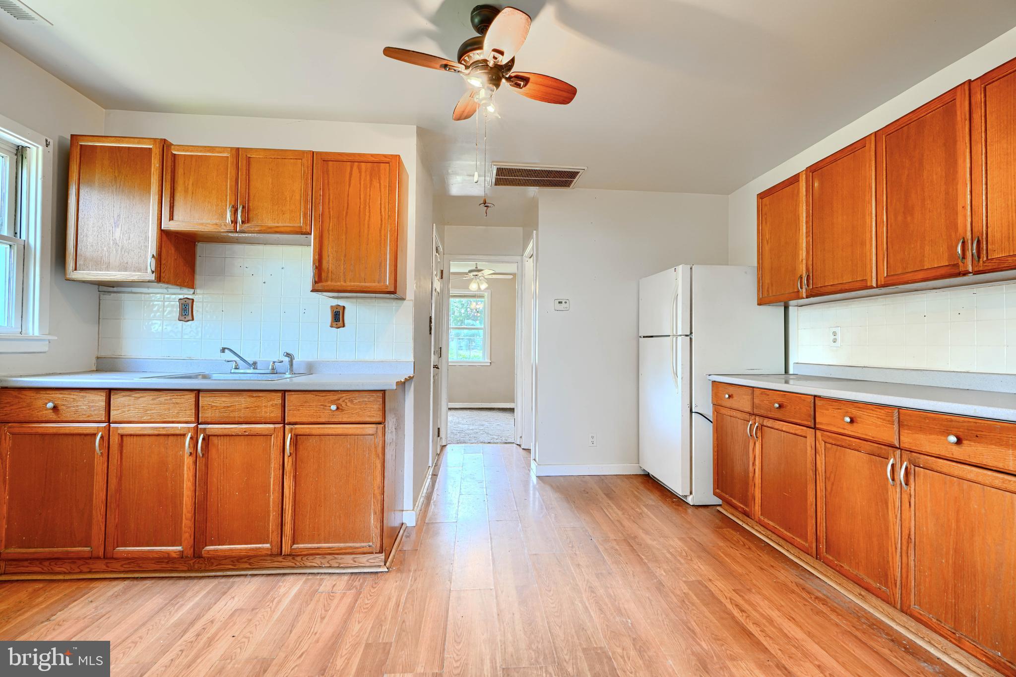 1702 Wilson Point Road Middle River, MD 21220 - Photo 7 of 32 a kitchen with granite countertop wooden floors a sink and appliances