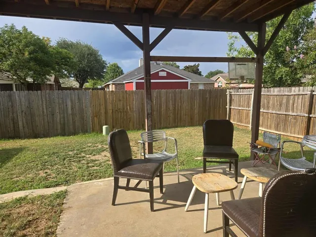 a patio with table and chairs
