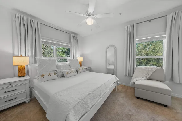 a bedroom with a bed couch and a window