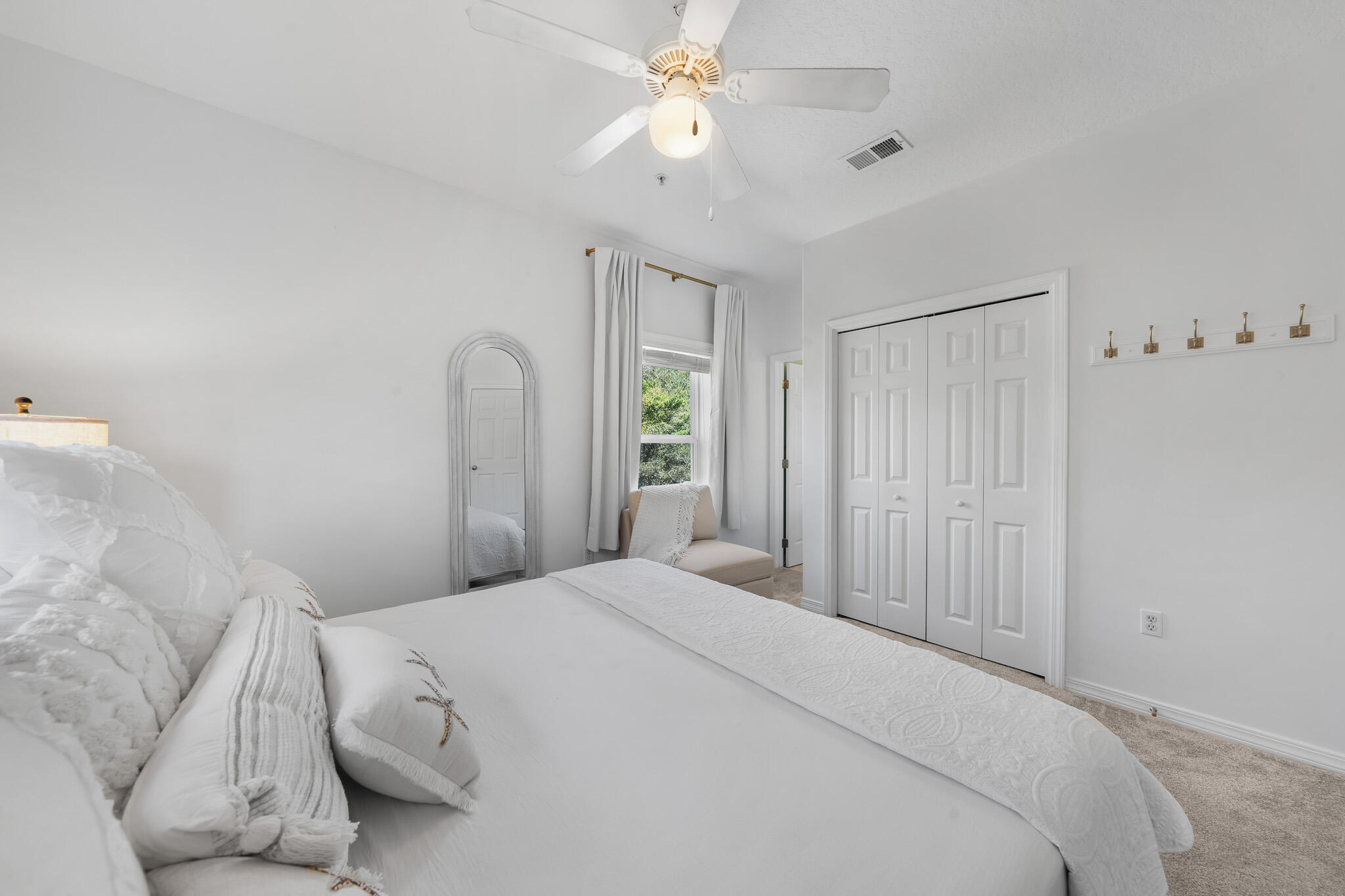 34 Heron's Watch Way, Unit 7205 Santa Rosa Beach, FL 32459 - Photo 22 of 49 a bedroom with a bed and a chandelier