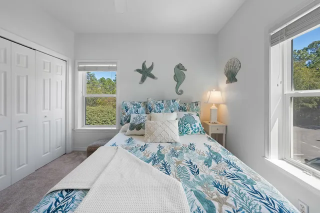 a bedroom with a large bed and a window