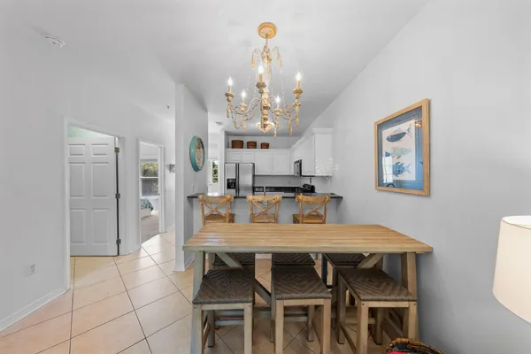 a view of a dining room with furniture and chandelier