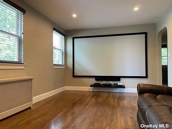a room with furniture projector screen and window