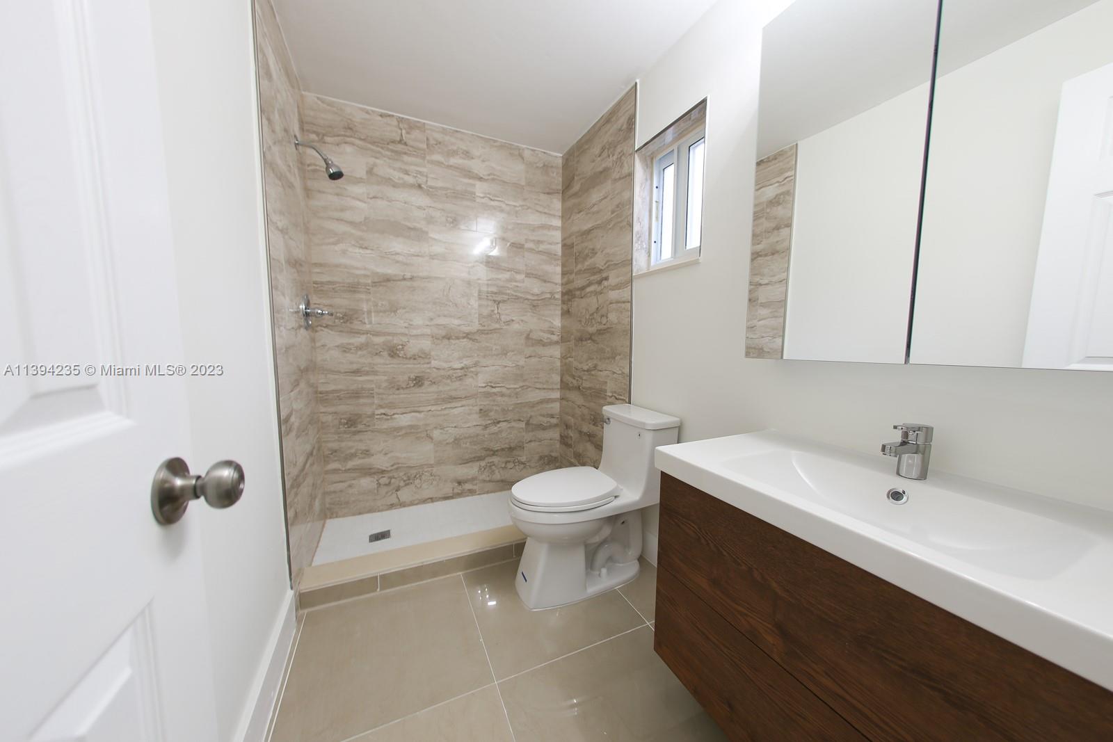 5410 Southwest 4th Street Miami, FL 33134 - Photo 14 of 23 a bathroom with a sink a toilet and shower