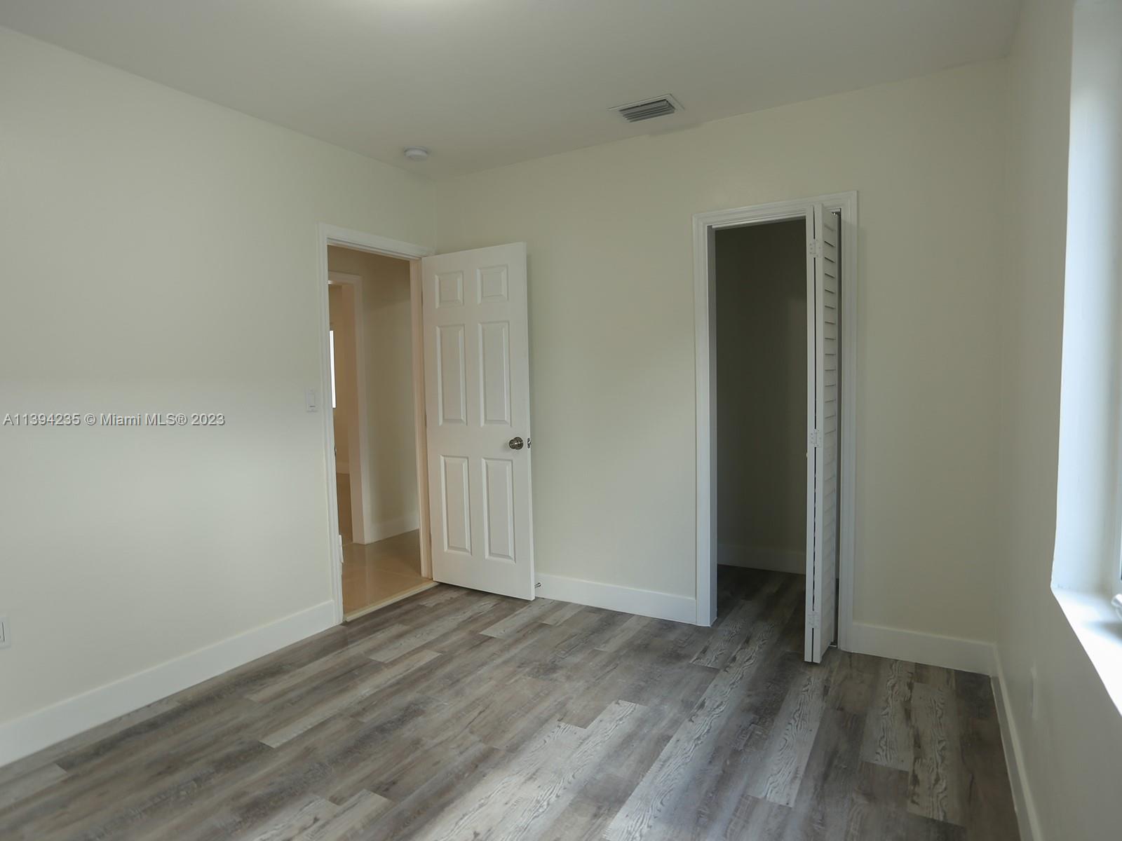 5410 Southwest 4th Street Miami, FL 33134 - Photo 16 of 23 an empty room with wooden floor and closet