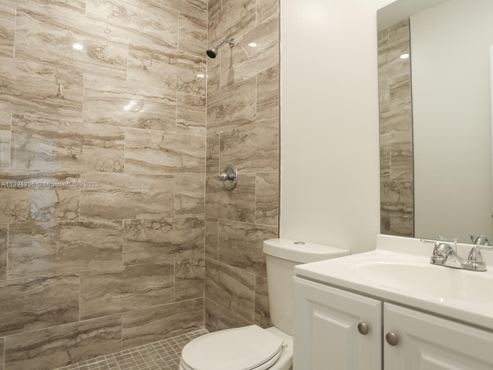 5410 Southwest 4th Street Miami, FL 33134 - Photo 18 of 23 a bathroom with a sink a toilet and a mirror