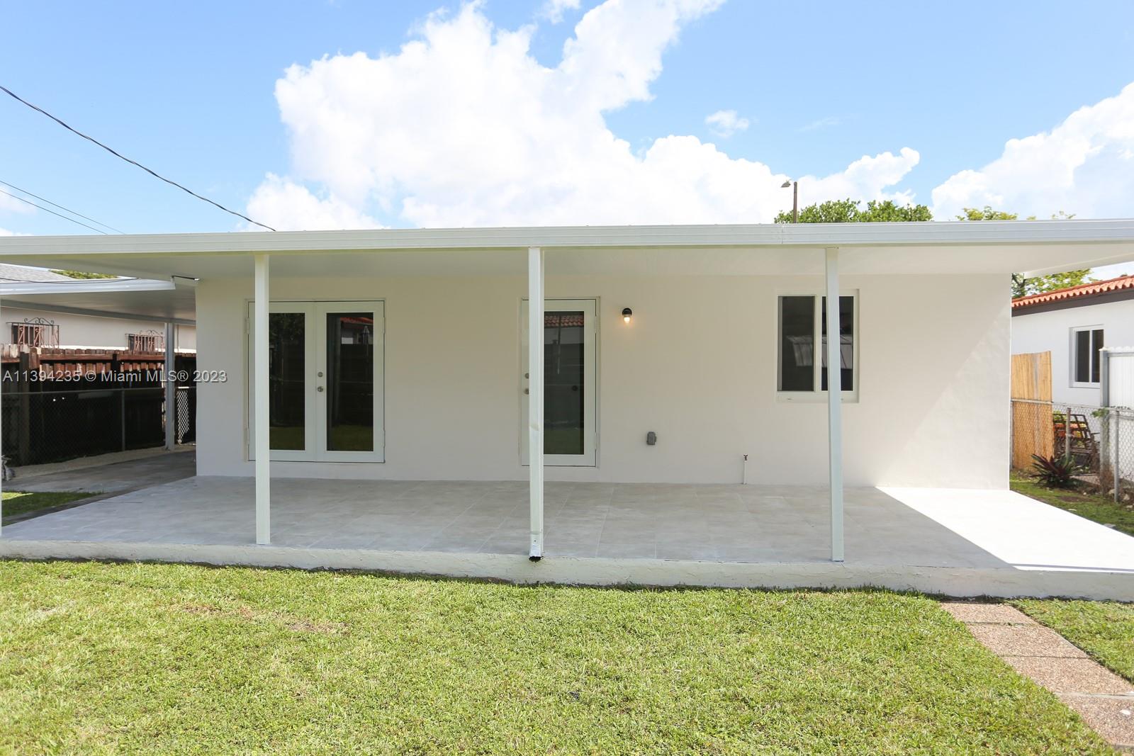 5410 Southwest 4th Street Miami, FL 33134 - Photo 20 of 23 a view of a patio with table and chairs and floor to ceiling window