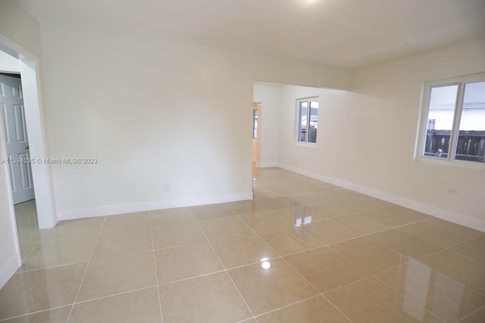 5410 Southwest 4th Street Miami, FL 33134 - Photo 5 of 23 an empty room with windows and entrance