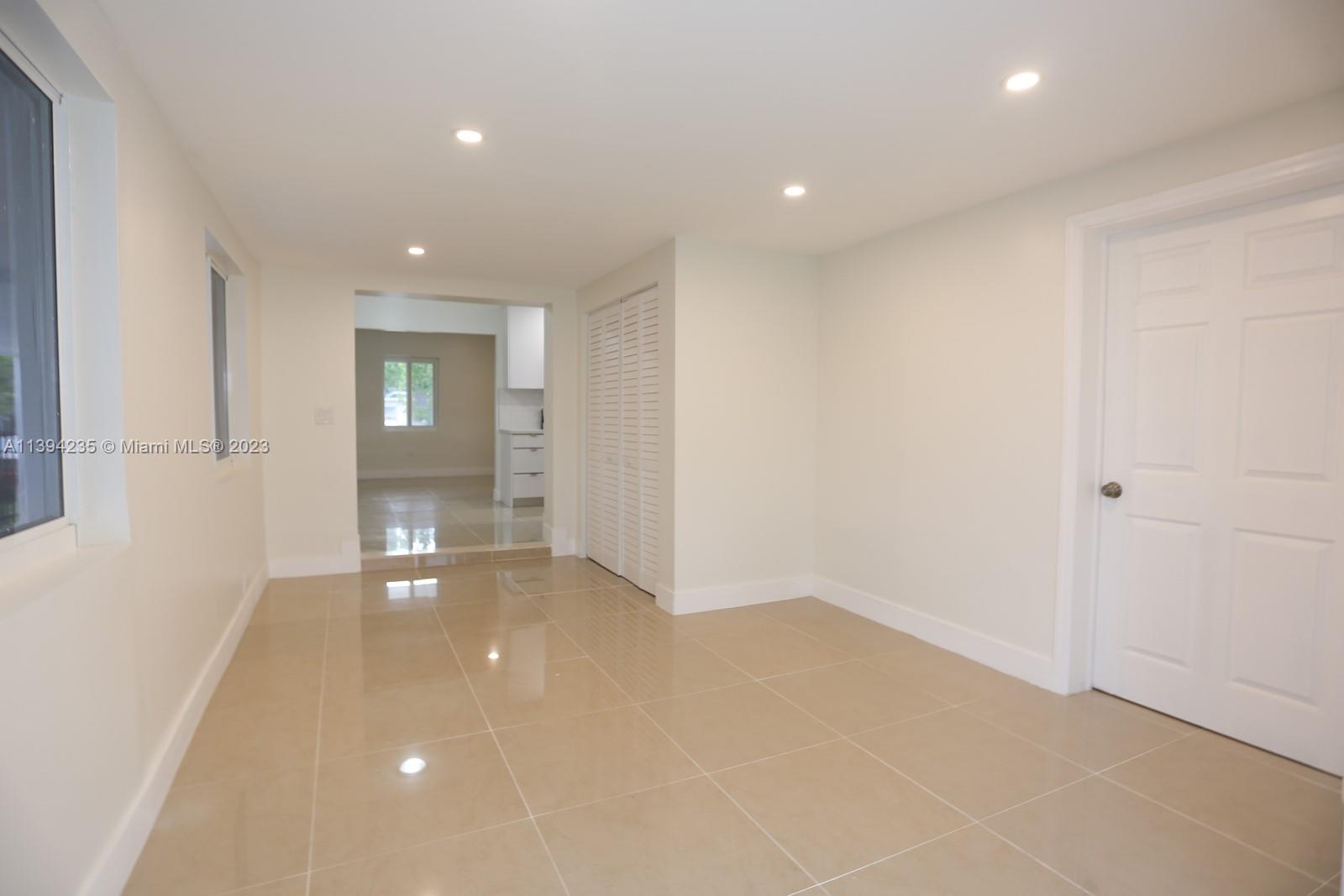 5410 Southwest 4th Street Miami, FL 33134 - Photo 10 of 23 an empty room with windows and entrance