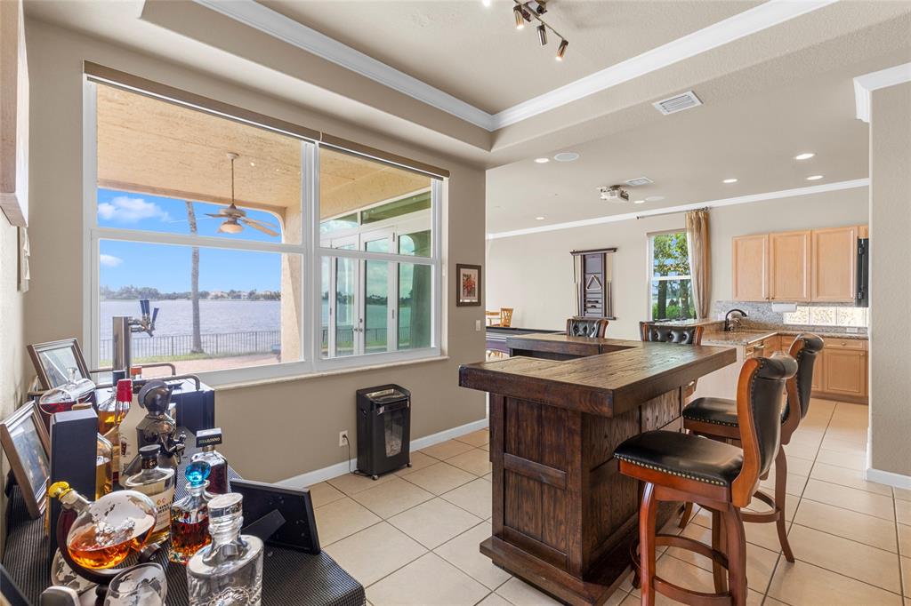 18932 Southwest 33rd Court Miramar, FL 33029 - Photo 11 of 97 a room with furniture a large window and a chandelier