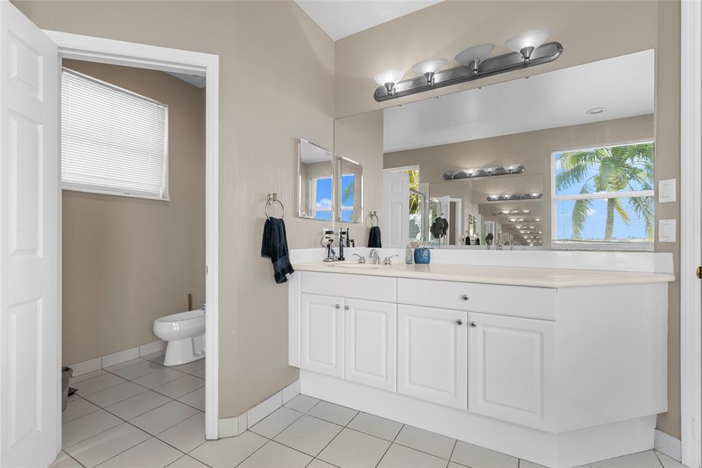 18932 Southwest 33rd Court Miramar, FL 33029 - Photo 23 of 97 a bathroom with a sink a toilet and a mirror