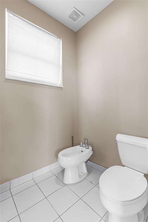 18932 Southwest 33rd Court Miramar, FL 33029 - Photo 24 of 97 a white toilet sitting next to a bathroom sink