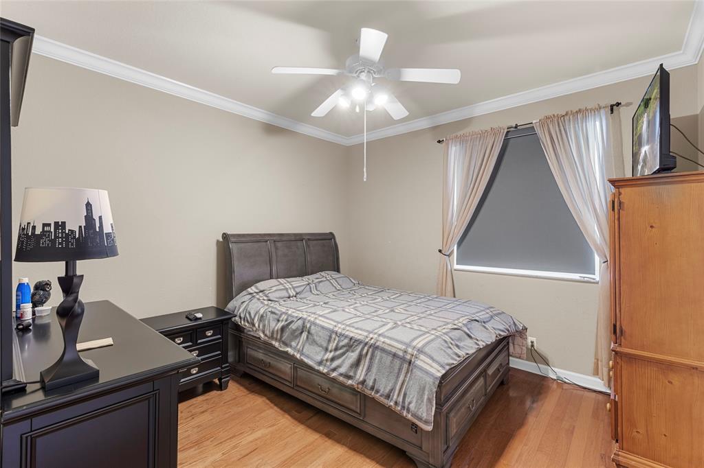 18932 Southwest 33rd Court Miramar, FL 33029 - Photo 28 of 97 a bedroom with a bed and a chandelier