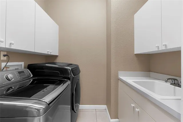 an aerial view of a house with a yard and tennis court