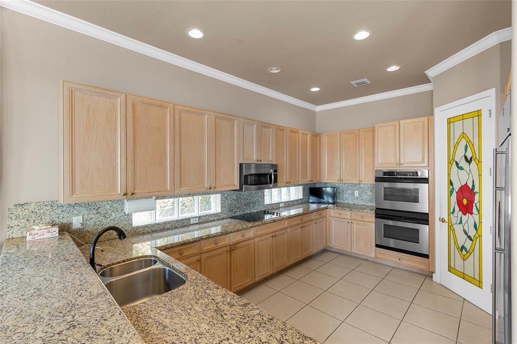 18932 Southwest 33rd Court Miramar, FL 33029 - Photo 8 of 97 a kitchen with stainless steel appliances granite countertop a sink and cabinets
