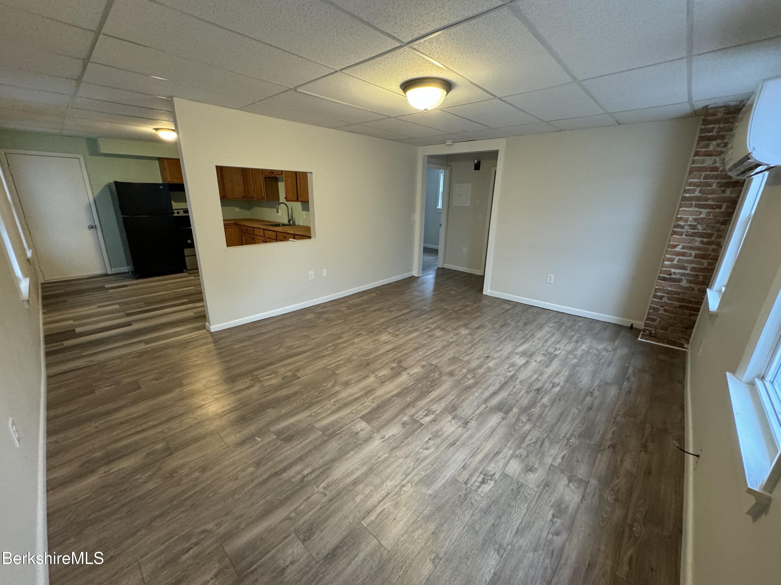 84 Summer Street, Unit B Adams, MA 01220 - Photo 6 of 8 a view of an empty room with wooden floor and a window