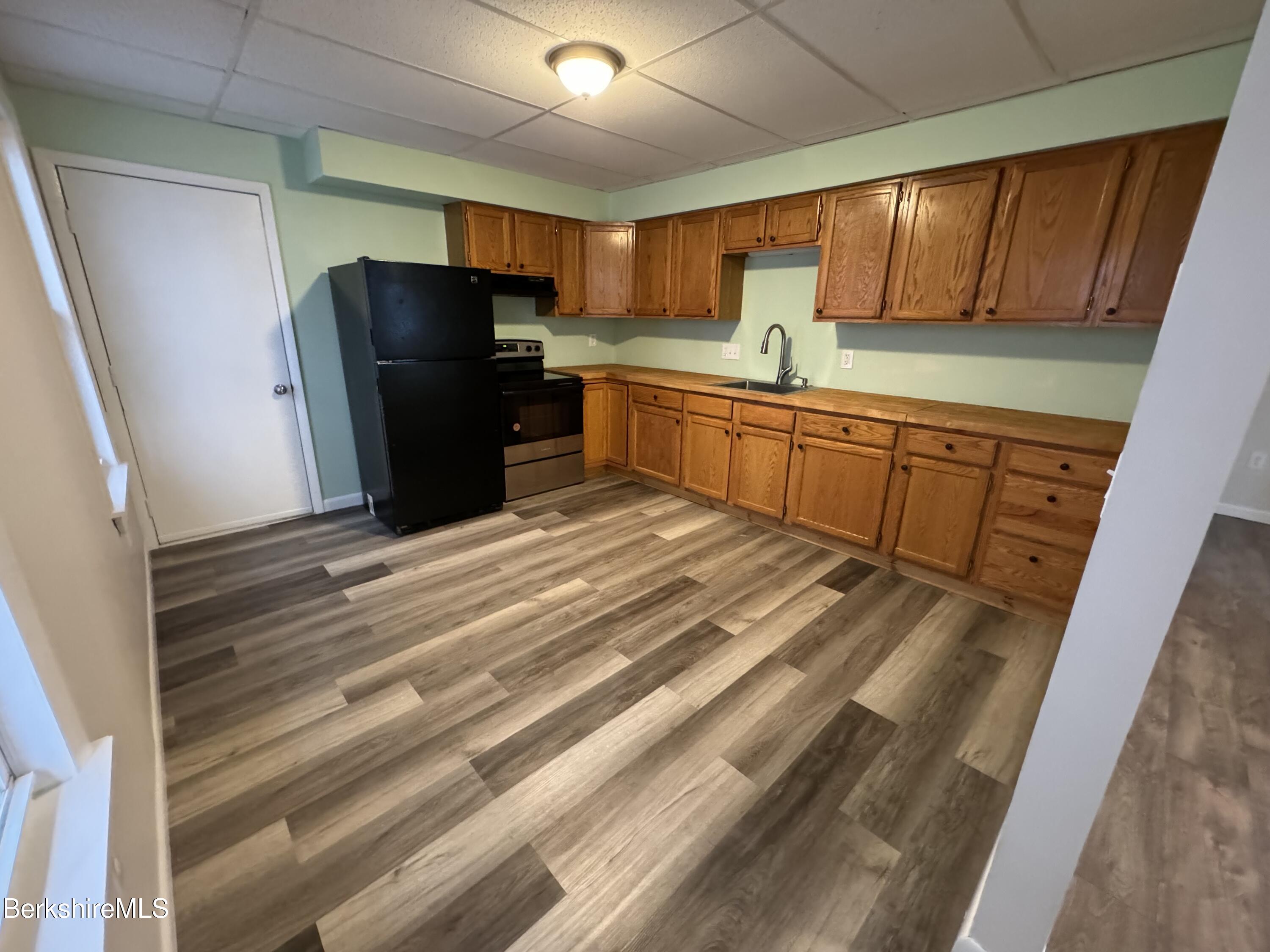 84 Summer Street, Unit B Adams, MA 01220 - Photo 7 of 8 a kitchen with refrigerator cabinets and a sink