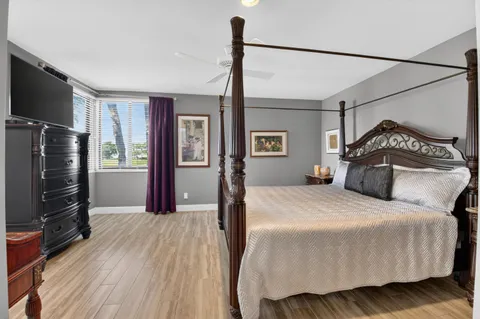 a bedroom with a large bed and a window