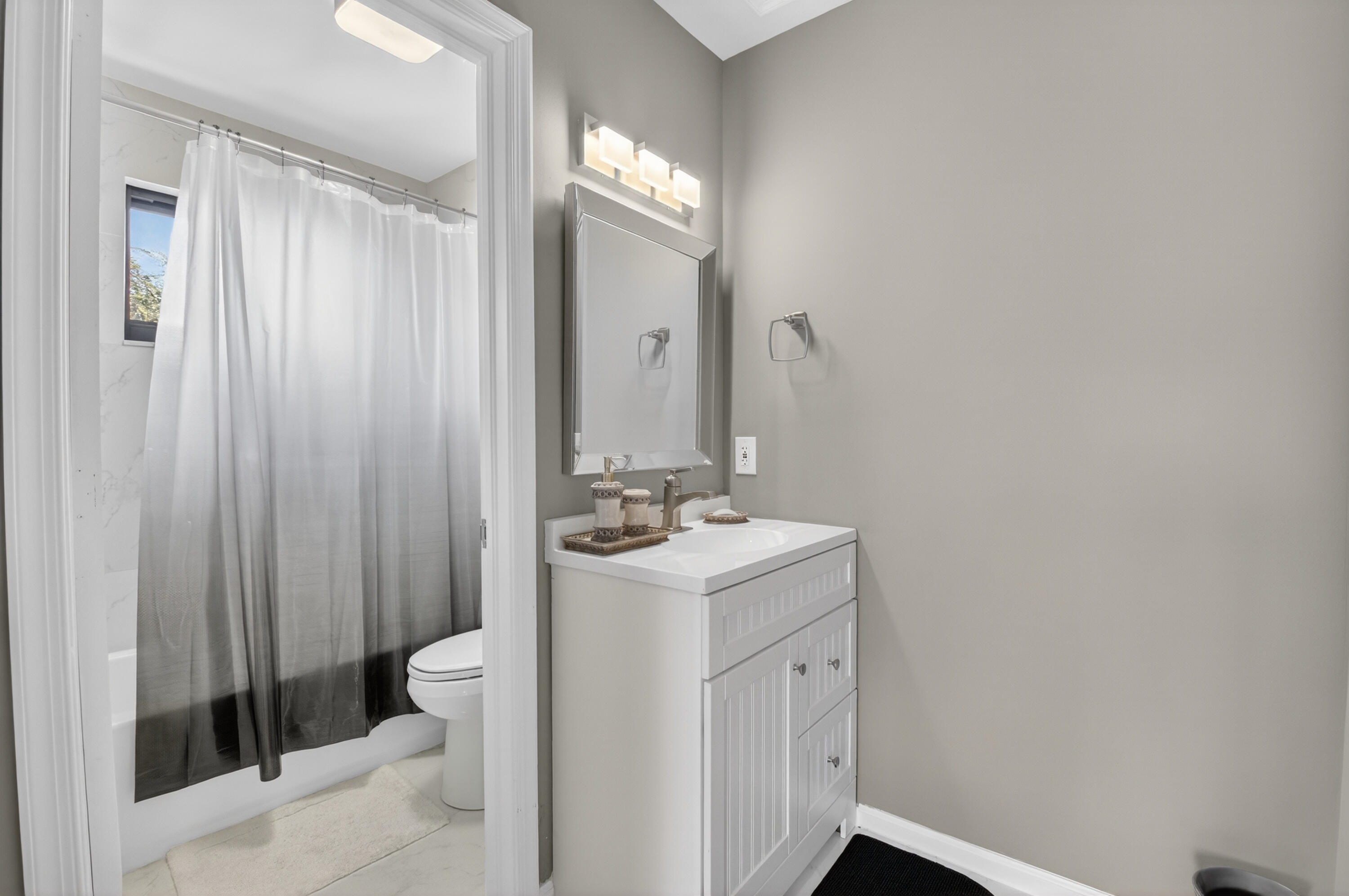 19407 Sabal Lake Drive, Unit 5016 Boca Raton, FL 33434 - Photo 31 of 97 a bathroom with a sink a toilet and shower