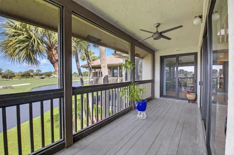a view of a house with backyard porch and sitting area