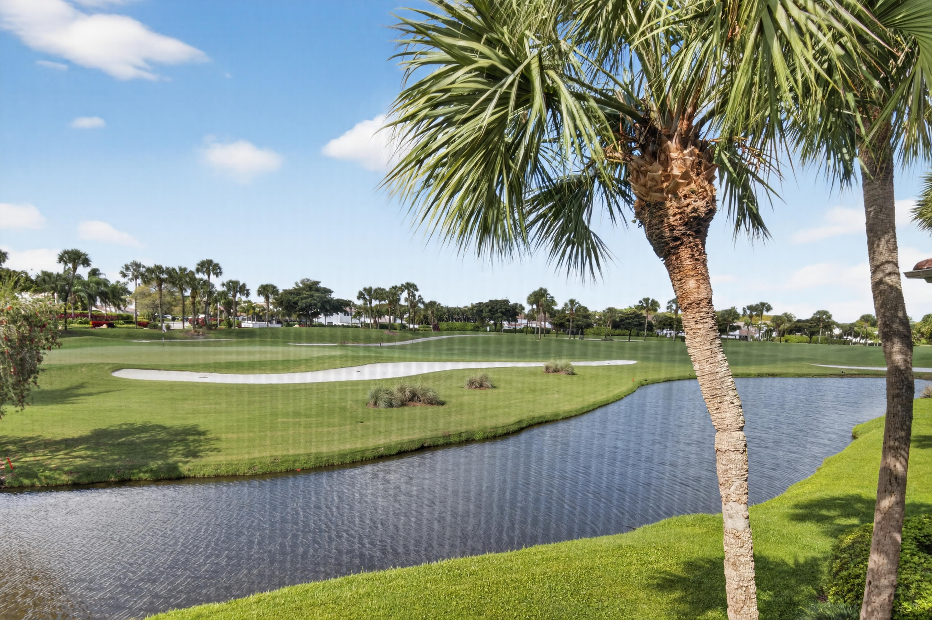 19407 Sabal Lake Drive, Unit 5016 Boca Raton, FL 33434 - Photo 42 of 97 a view of a lake with a garden