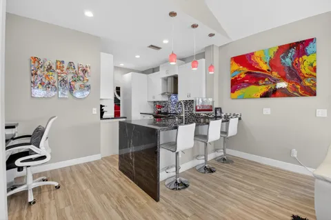 a kitchen with stainless steel appliances granite countertop a sink stove and cabinets