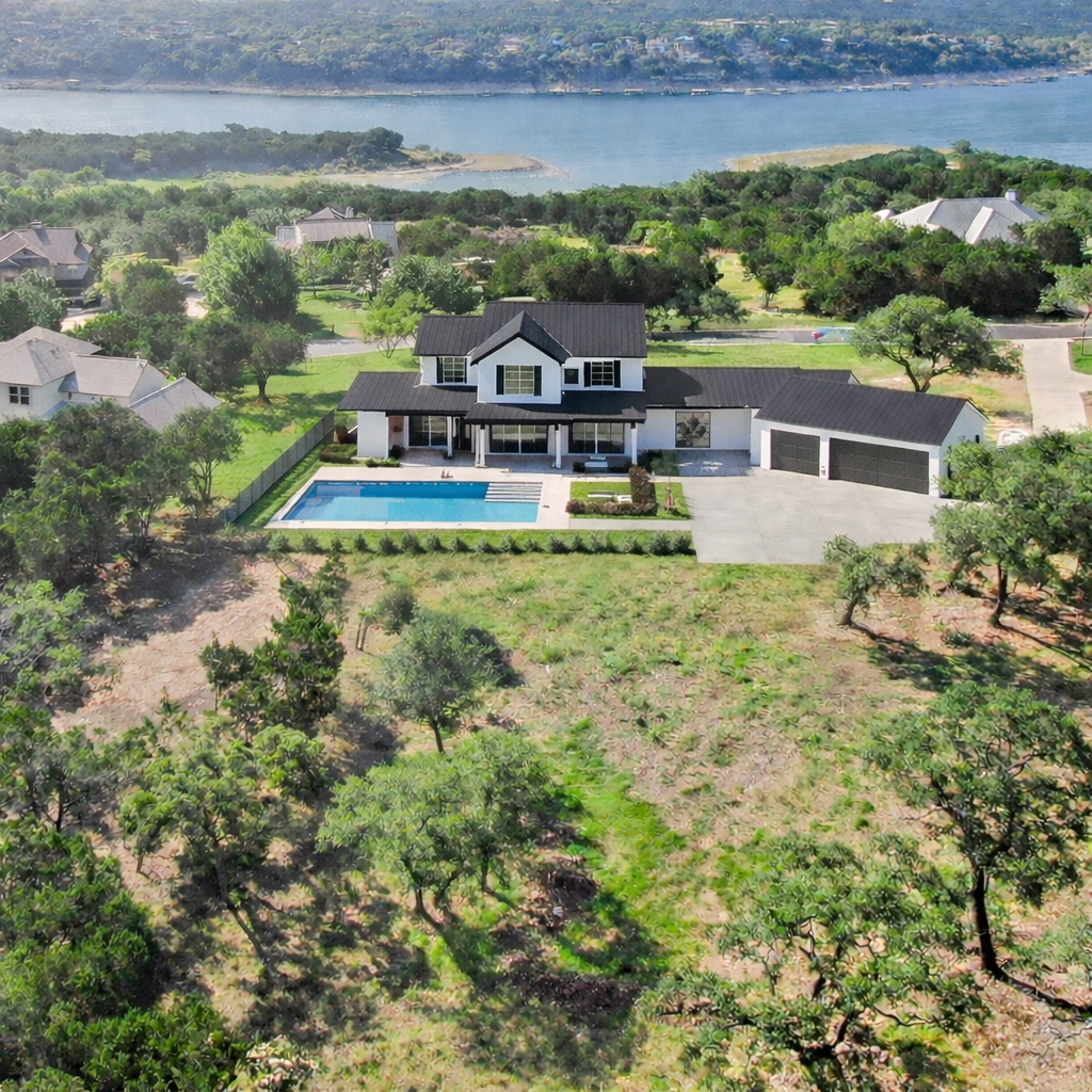 an aerial view of a house with a yard