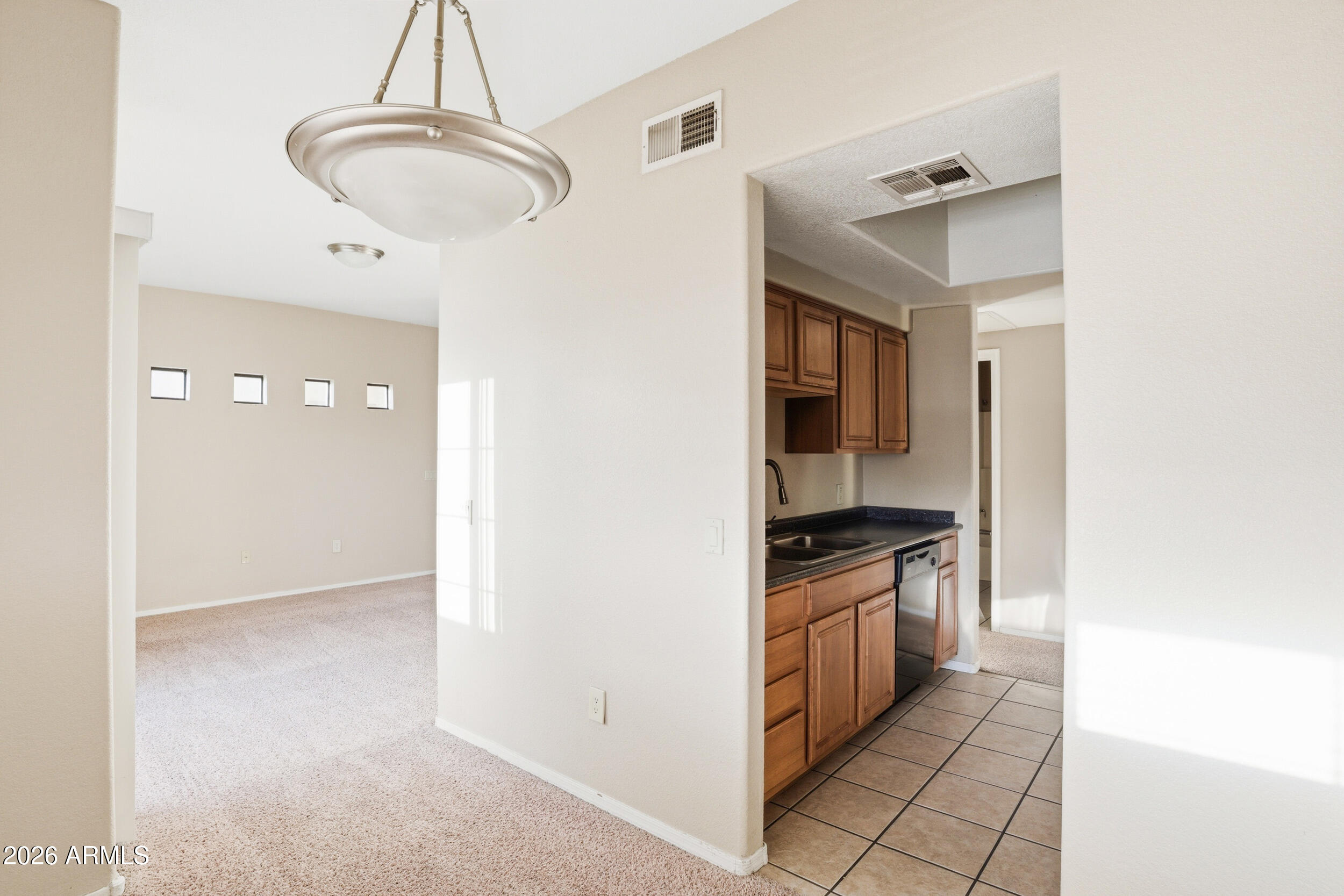 3434 East Baseline Road, Unit 264 Phoenix, AZ 85042 - Photo 5 of 12 a kitchen with granite countertop a stove and a sink