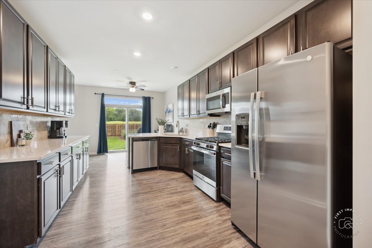 2045 Stuttle Road Batavia, IL 60510 - Photo 11 of 20 a kitchen with stainless steel appliances a refrigerator a sink a stove and cabinets