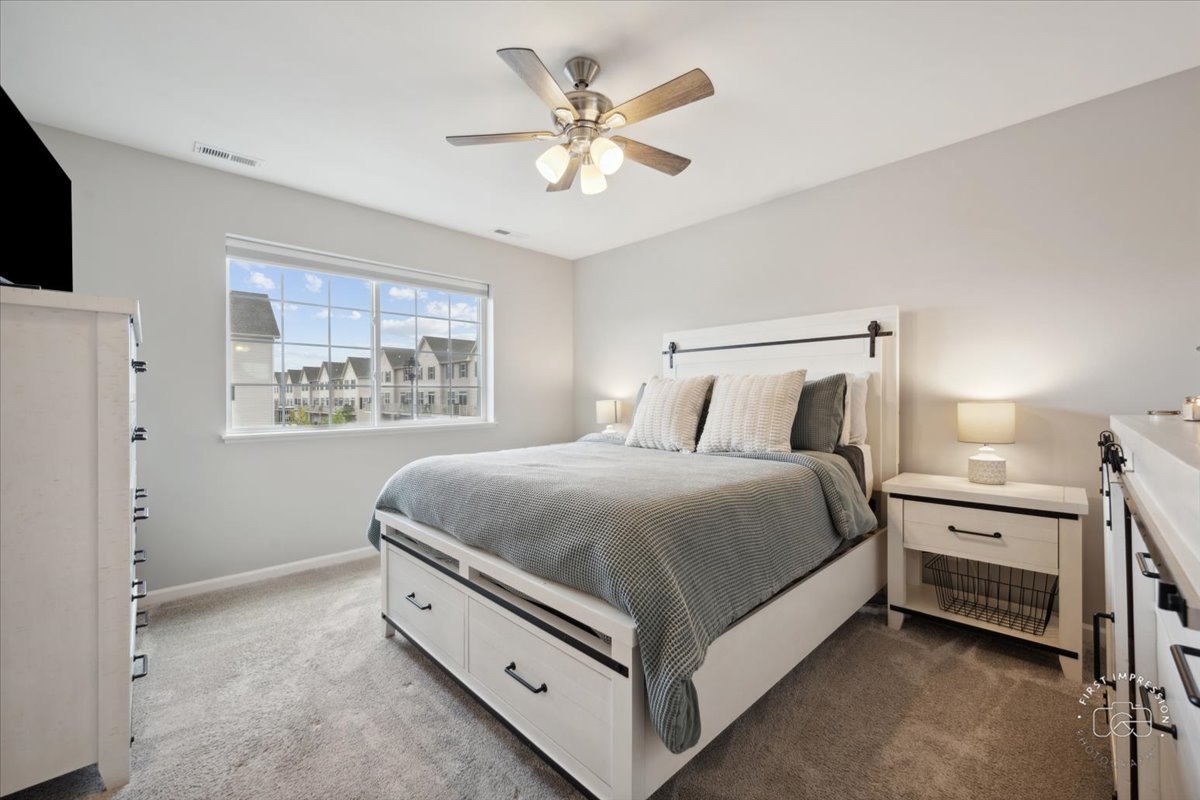 2045 Stuttle Road Batavia, IL 60510 - Photo 13 of 20 a spacious bedroom with a bed and a ceiling fan