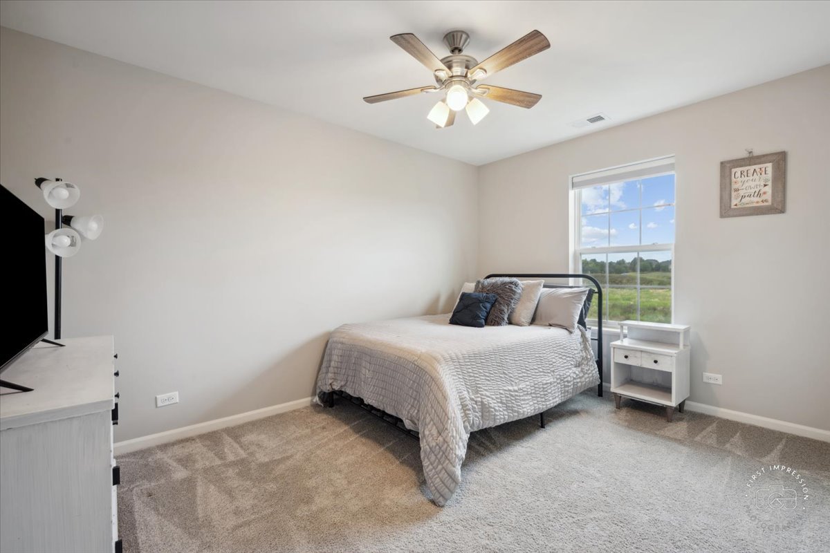 2045 Stuttle Road Batavia, IL 60510 - Photo 15 of 20 a spacious bedroom with a bed and a flat tv screen on the wall