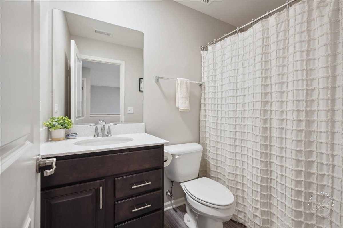 2045 Stuttle Road Batavia, IL 60510 - Photo 18 of 20 a bathroom with a granite countertop toilet sink and mirror