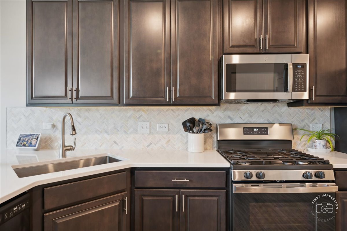 2045 Stuttle Road Batavia, IL 60510 - Photo 9 of 20 a kitchen with granite countertop a sink stainless steel appliances and cabinets