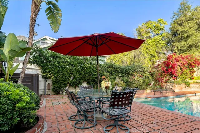 a view of backyard with seating space and trees