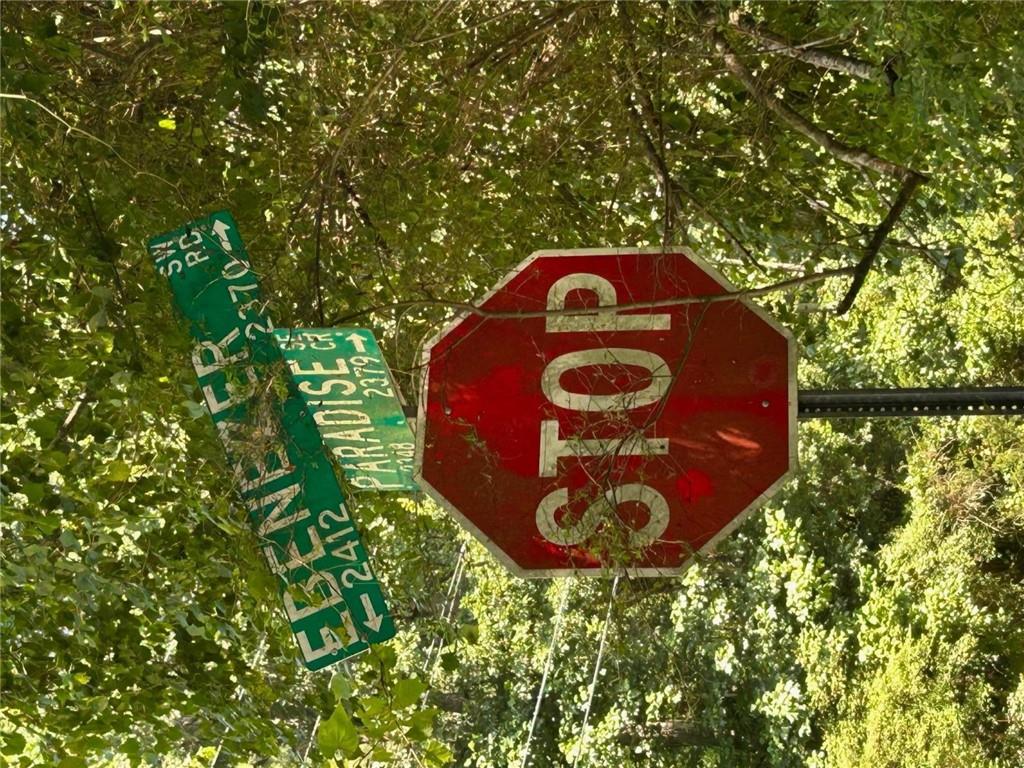 2370 Ebenezer Road Southwest Conyers, GA 30094 - Photo 5 of 5 a view of a outdoor space with signage and trees