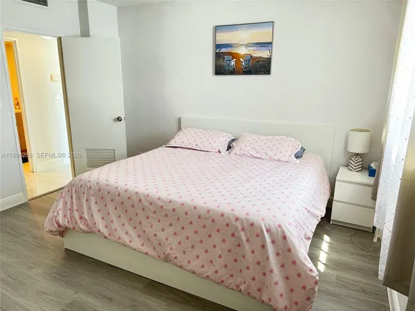 a bedroom with a bed and a mirror