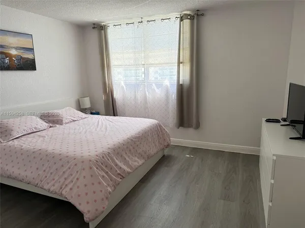 a large bed sitting in a bathroom next to a window