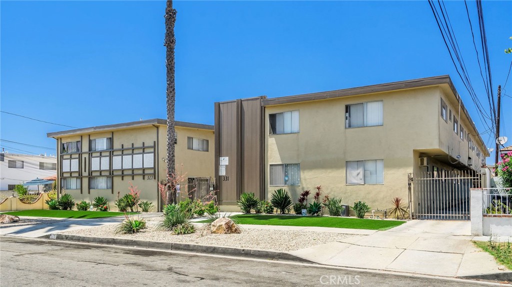327 Stepney Street Inglewood, CA 90302 - Photo 13 of 13 a front view of a house with a garden and plants