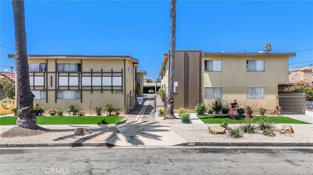 327 Stepney Street Inglewood, CA 90302 - Photo 2 of 13 a front view of a house with a garden