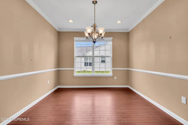 a view of a room with wooden floor and a window