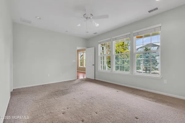 a view of a kitchen with a refrigerator a ceiling fan and a kitchen view