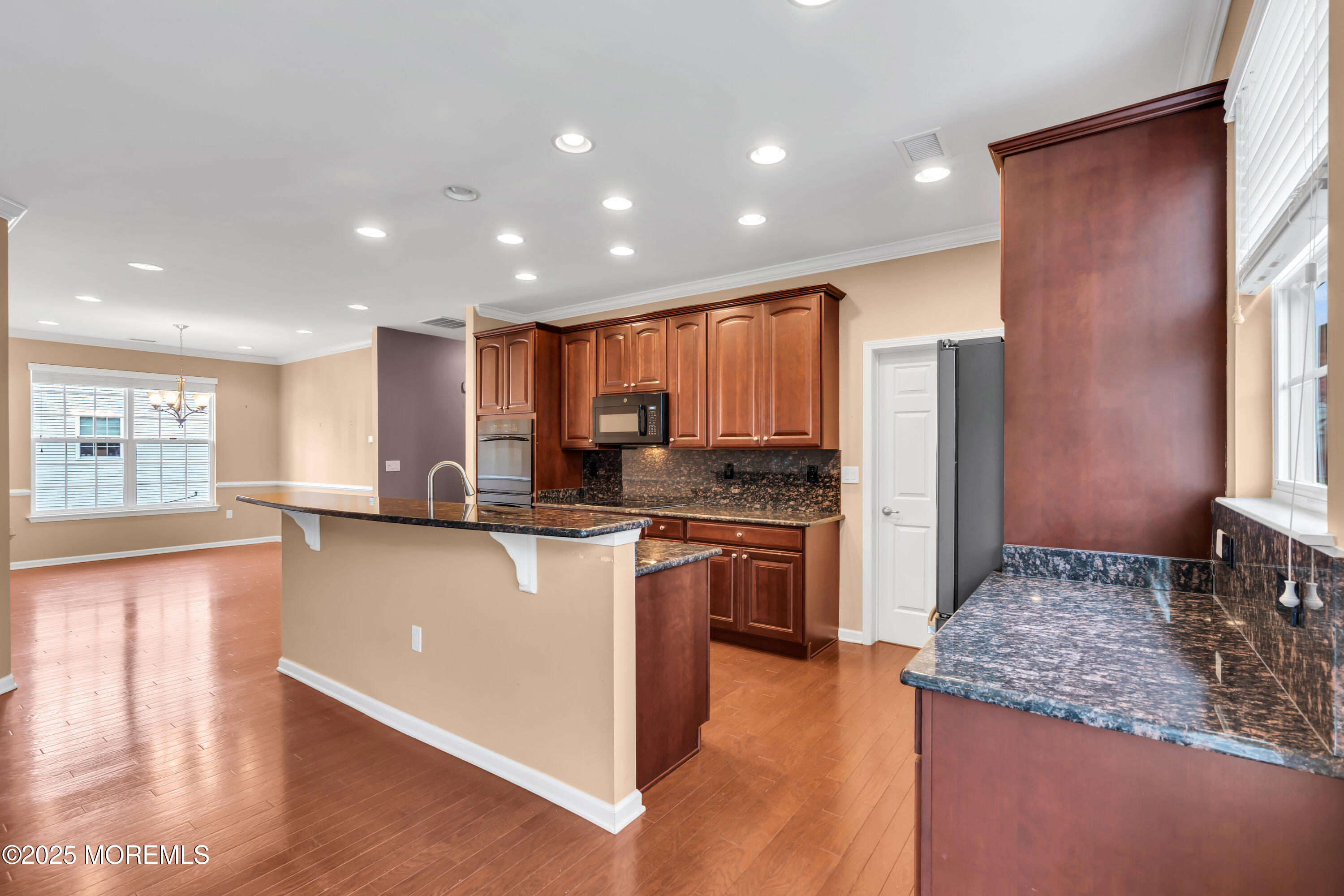 42 Pembroke Drive Jackson, NJ 08527 - Photo 17 of 44 a kitchen with stainless steel appliances granite countertop a refrigerator a stove and a sink with wooden floor