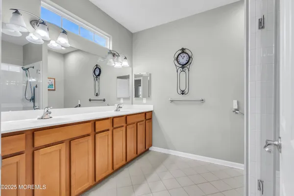 a kitchen with stainless steel appliances granite countertop a refrigerator a stove and a sink with wooden floor